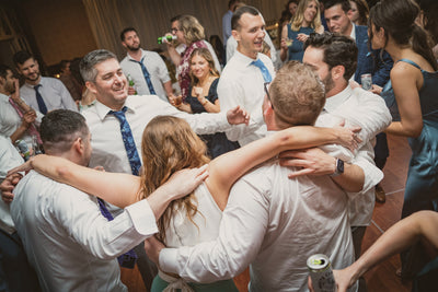 A group of people enjoying a heartfelt dance at a wedding.