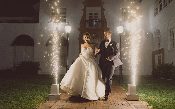 This description captures the dreamy ambiance of a wedding with sparks flying as a bride and groom walk down a brick walkway, celebrating their love with a stunning sparkler send-off.