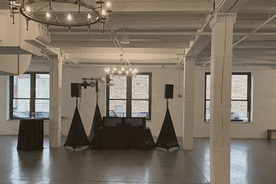 A DJ booth with speakers and lights, ready for an amazing wedding dance party
